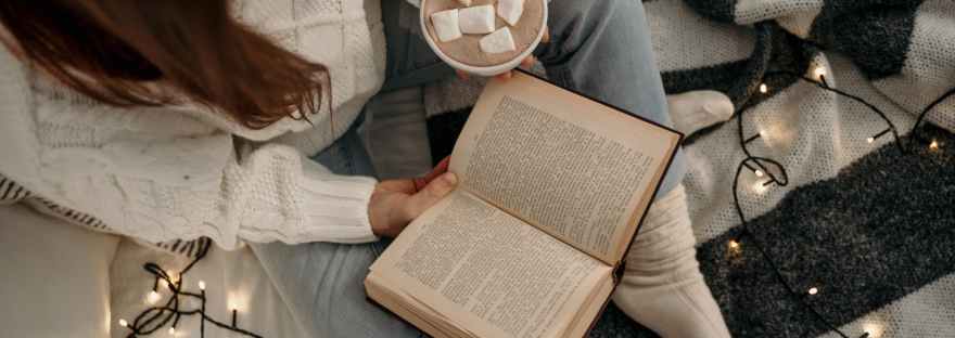 woman in white long sleeve shirt reading book
